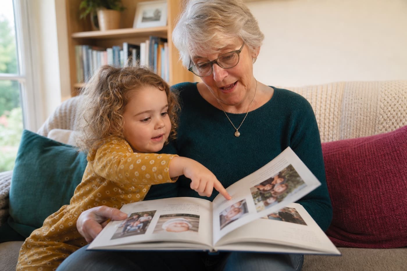 A child and family member looking through a printed baby keepsake book together